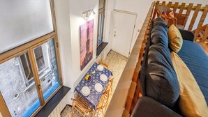 A room with a wooden bed, a dining table with chairs, a window with blinds, and a wall-mounted picture. - Da Stefano Historical Center 5 min to Aquarium (Genoa)
