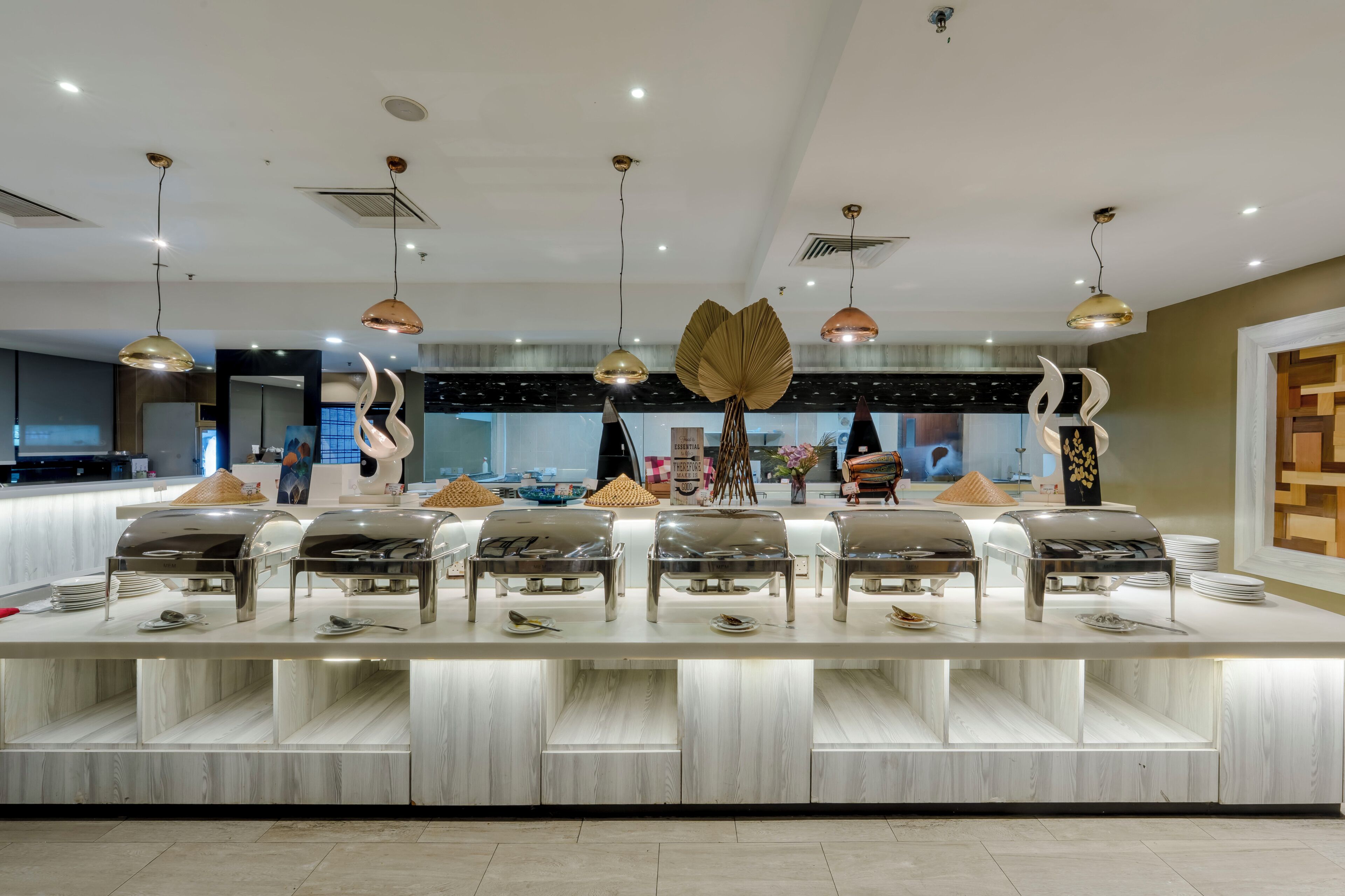 A modern hotel lobby with a reception desk, multiple seating areas, and contemporary lighting fixtures.