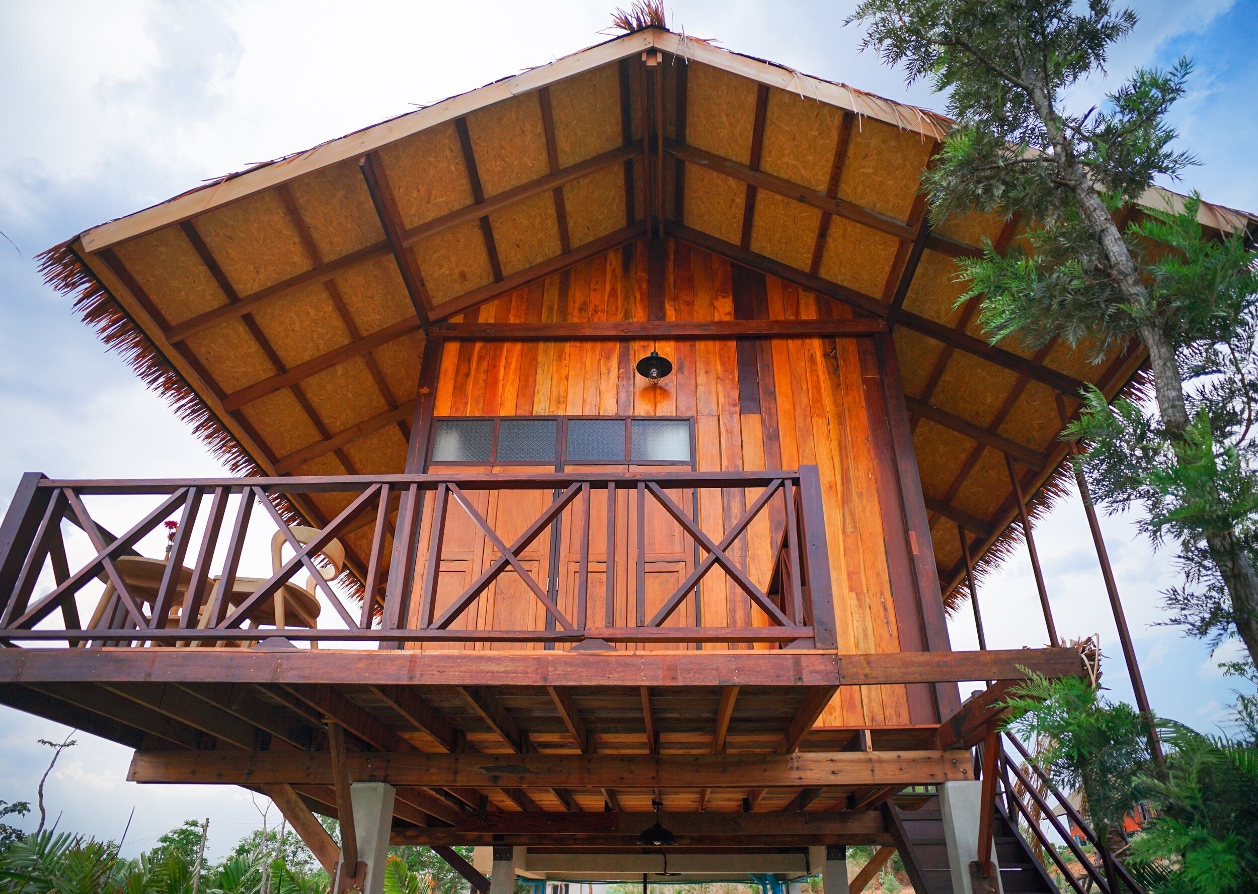 A wooden structure with a balcony, a window, and a door.
