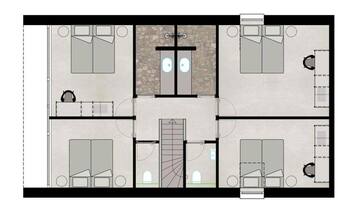 A floor plan of a hotel with four bedrooms, a bathroom, a kitchen, and a central area with a staircase.