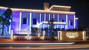 A modern building with a prominent 'Morph' sign, featuring a clean architectural design with vertical lines and a flat roof. - morph Bangkok Hotel (Bangkok)