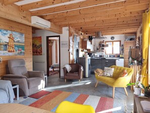 A cozy living room with a sofa, armchair, and a vibrant rug. - Chalet Retreat Private Self Contained 4 to 6 Person Mountain Views Own Terrace (Les Villards-sur-Thônes)