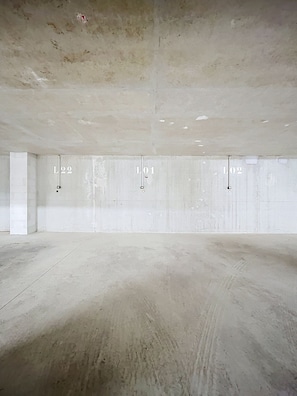 An empty room with a concrete floor and walls, labeled L01, L02, and L22. - The Douka Apartment—Sleeps 4—Near Downtown (Les Gets)