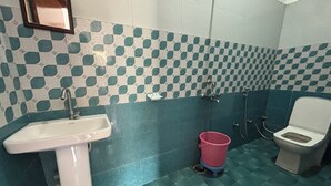 Un baño con lavamanos, inodoro y ducha.