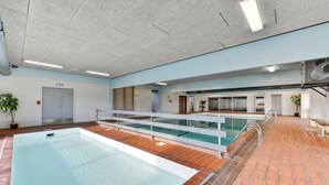 An indoor swimming pool with a tiled floor, a glass barrier, and a ceiling with recessed lighting. - Amazing home in Vestervig with sauna (Vestervig)