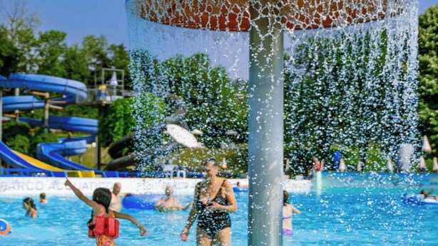 A water play area with a central water feature and slides in the background. - The Little House on the River (Castel Dè Ratti)