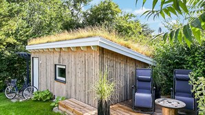 A small wooden structure with a grass roof, a door, and a window. - 3 bedroom amazing home in Ebeltoft (Ebeltoft)