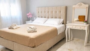 A bedroom with a bed, bedside table, and a dresser. - Nefeli Sea View Stay - Mastiha Grove Suite, Chios (Chios)