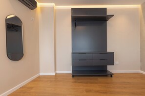 A modern closet with a mirror, built-in shelves, and drawers. - Prishtina City Apartments 2 (Pristina)