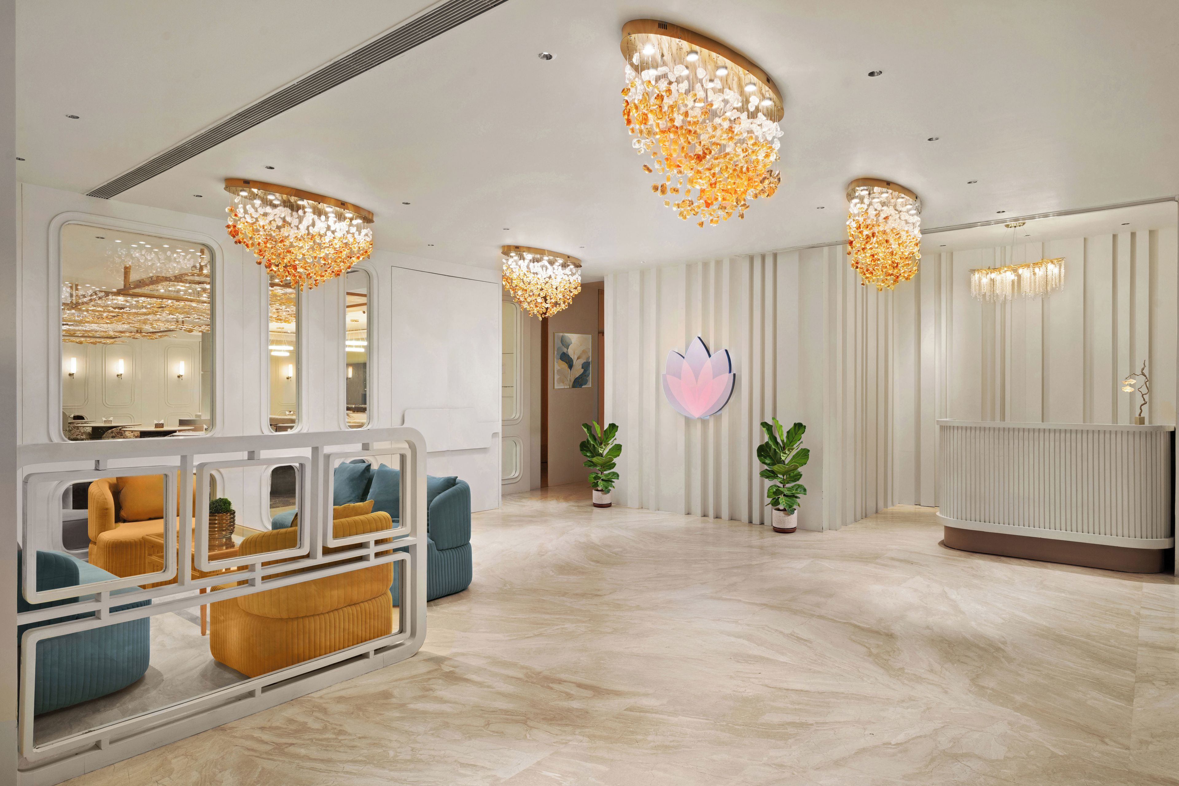 A modern interior with a reception desk, seating area, and decorative lighting.