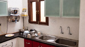 Una cocina con un lavamanos, armarios y una ventana.