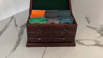 A wooden chest with compartments containing various tea boxes.