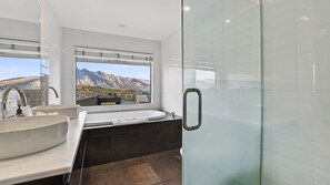 A modern bathroom with dual sinks, a bathtub, and a glass shower enclosure. - Alpine 75 Residence - Queenstown Hill 5 Bed (Queenstown)