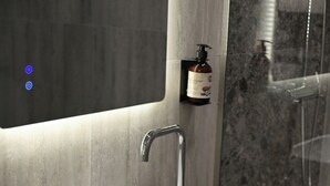 A modern bathroom with a white sink, a mirror, and a shower area. - Cosmos Luxury Studio Suites (Tirana)
