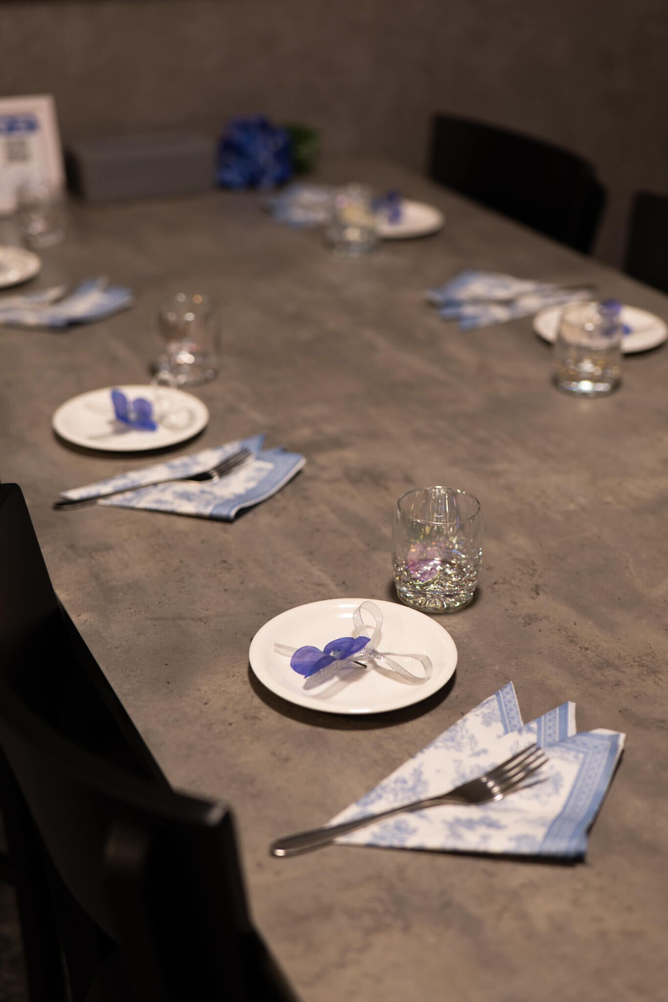 A table set with plates, cutlery, and glasses, arranged for a meal.