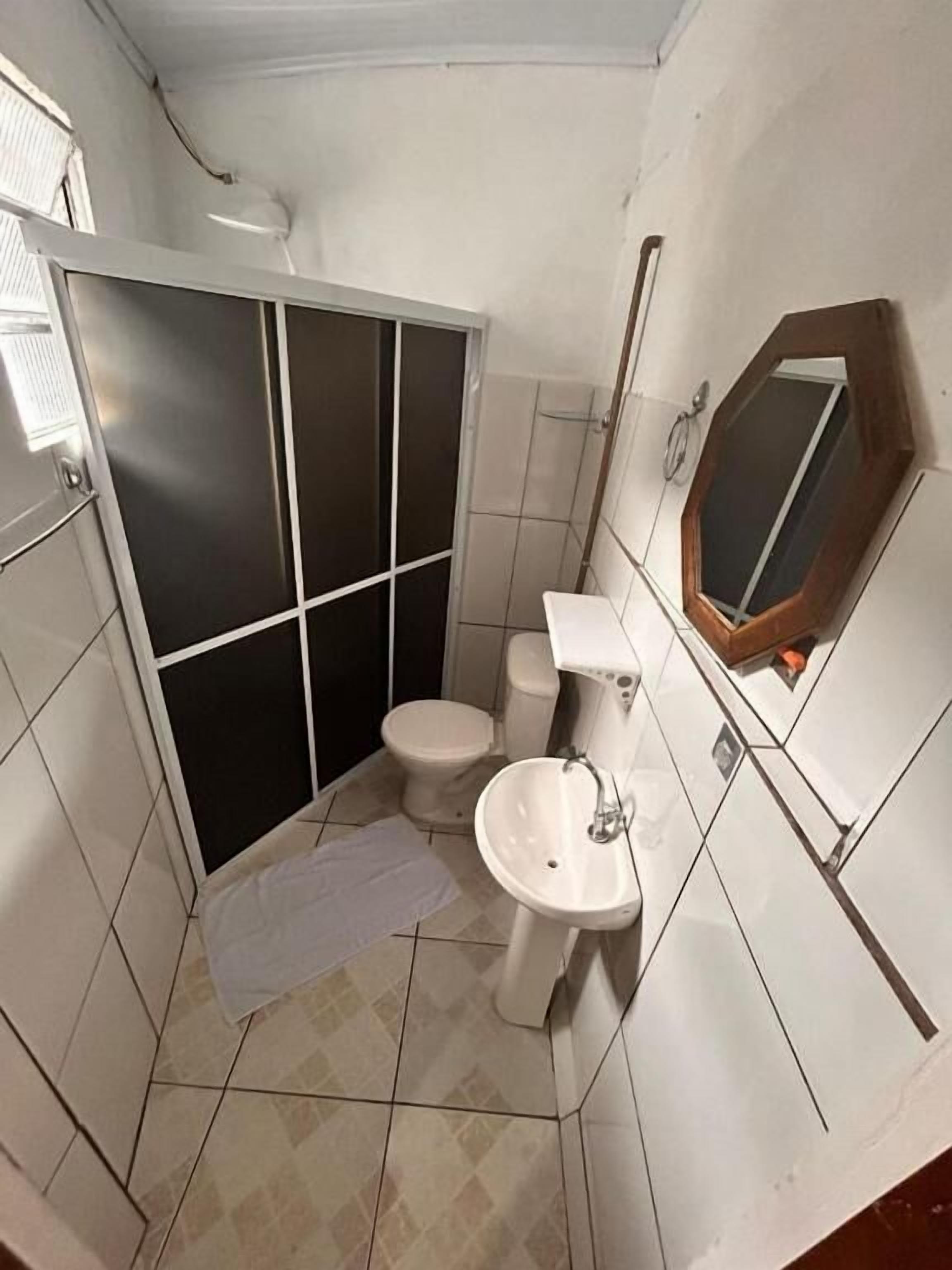 Economy Quadruple Room | Bathroom | Shower, towels, soap, toilet paper