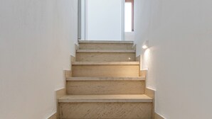A staircase with a handrail, leading to a door at the top. - Ageri House | Family Home in Vivlos, Naxos | Sleeps 6 (Vivlos)