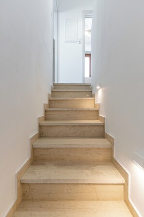 A staircase with a handrail, leading to a door at the top. - Ageri House | Family Home in Vivlos, Naxos | Sleeps 6 (Vivlos)