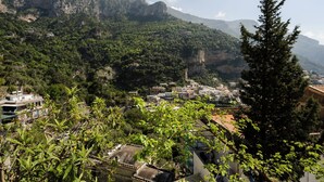 A mountainous landscape with buildings nestled among the hills. - A' Malafemmena  (Positano)