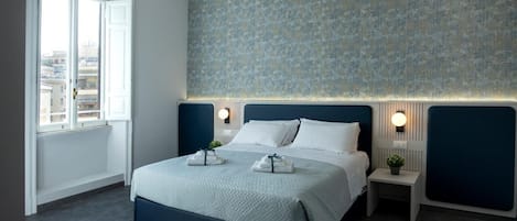 A modern bedroom with a large bed, bedside tables, a window, and a patterned wall.