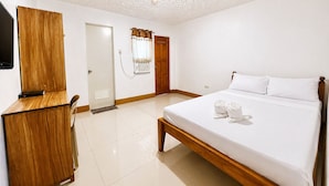 A hotel room with a bed, a desk, a television, and a shower. - Bethel by the Sea Santa Fe Bantayan Island (Cebu City)