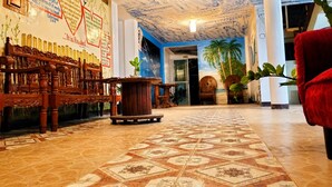 A spacious lobby with a patterned floor, wooden furniture, and a blue ceiling. - Bethel by the Sea Santa Fe Bantayan Island (Cebu City)