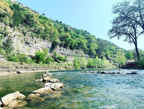 A river with clear water, rocks, and a tree on the right. - Exciting Family Vacation with Kayaks, Canoes, and More: Comfortable Bell Tent near New Braunfels, Texas (Kingsbury)