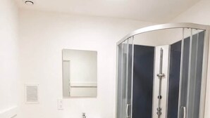A bathroom with a toilet, a sink, and a glass-enclosed shower. - 8. Snooze 8H Brussels Charleroi Airport (Charleroi)