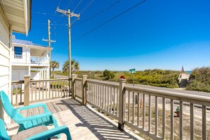 A wooden deck with a railing, a white building with a balcony, and a clear view of the beach and ocean. - Sea Breeze enjoy oceanviews and a charming 3-bedroom retreat in Surf City. (Surf City)