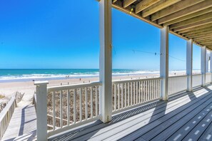 A wooden deck with a railing overlooking a beach. - Sea Escape - Incredible Oceanfront 8 BR Home in Gated Community (North Topsail Beach)