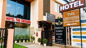 A hotel entrance with signs for 'Hotel The Cressida' and 'The Cressida Luxurious AC Room'. - The Cressida Hotel (Indore)