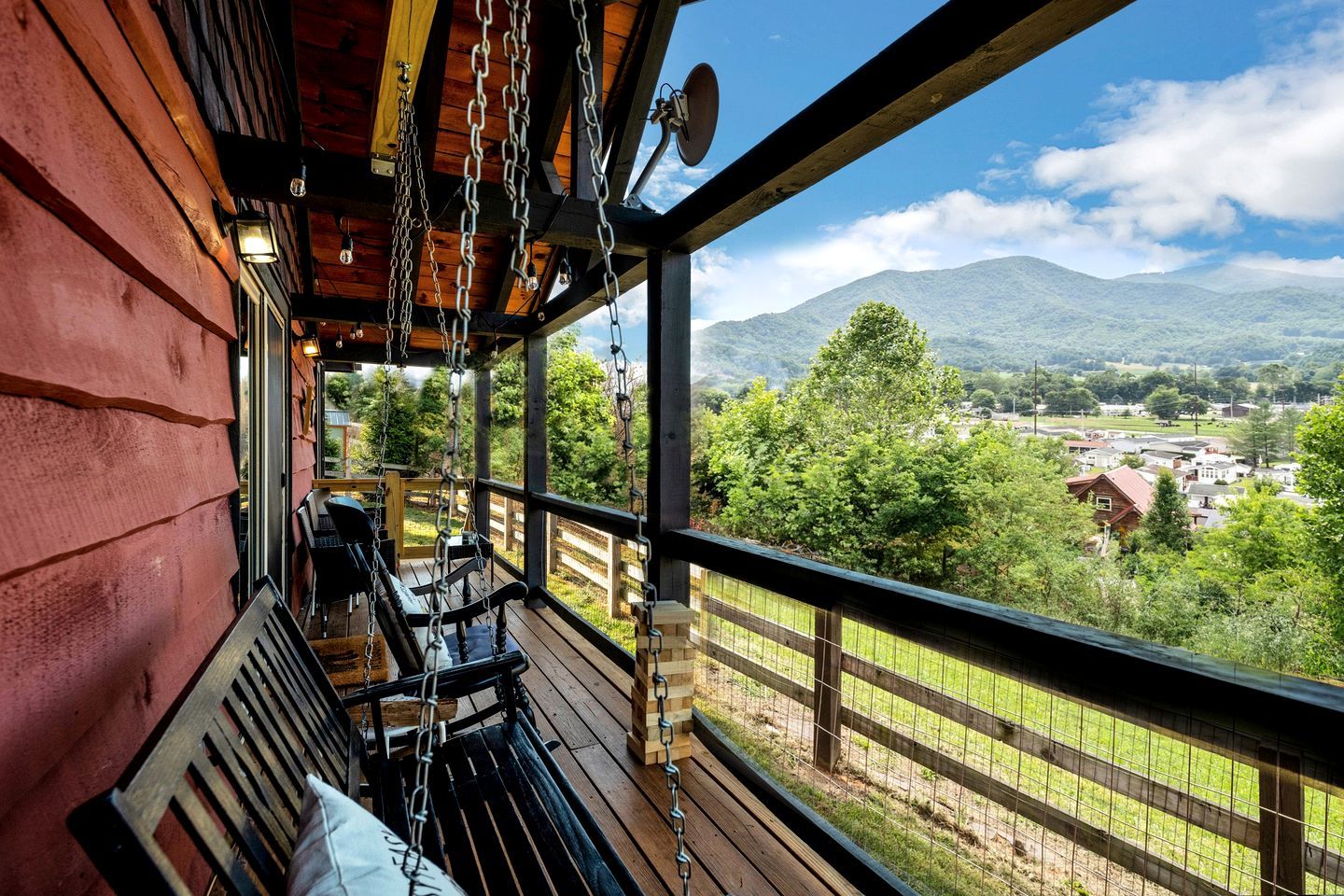 A wooden deck with a view of a mountainous landscape.