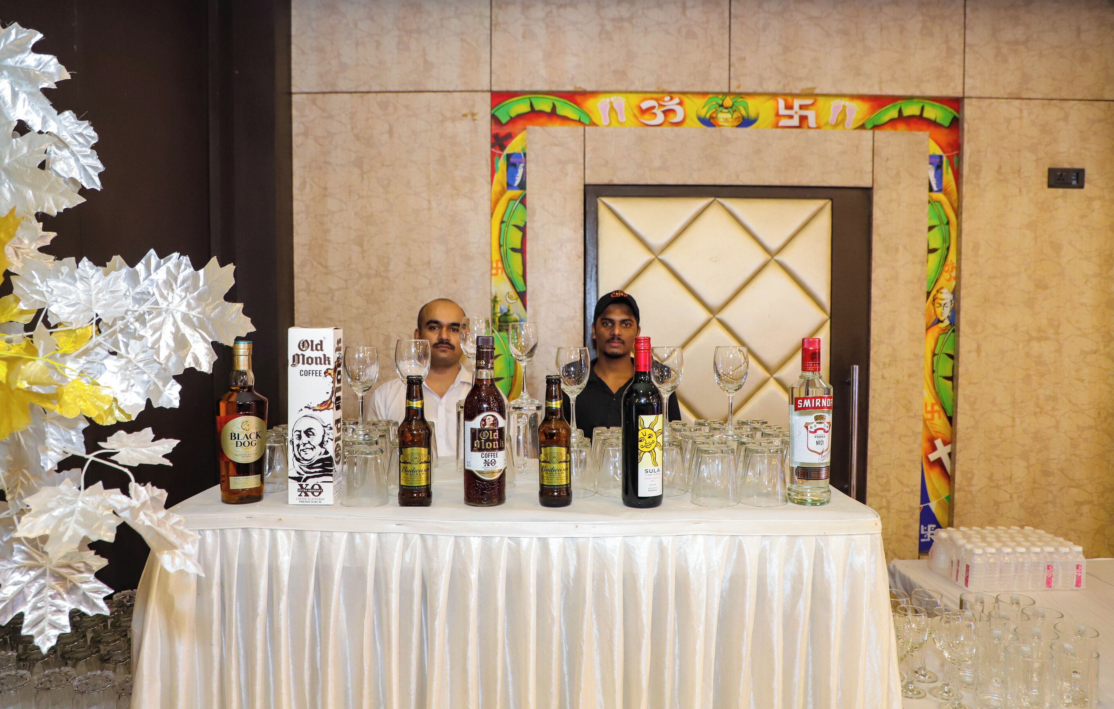 A table with various bottles and glasses, likely for a tasting event.