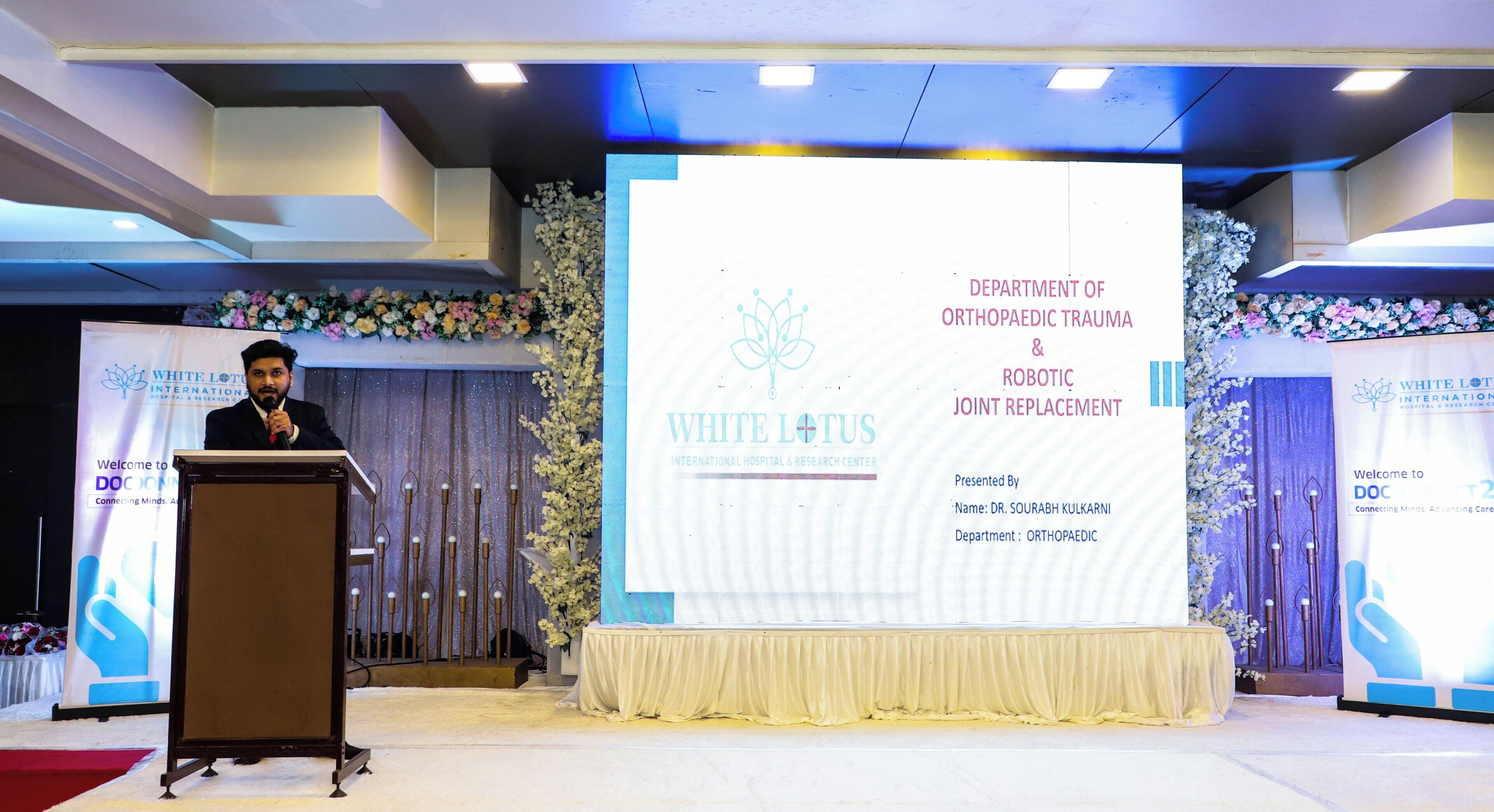 A stage with a podium and a presentation screen for a medical conference.