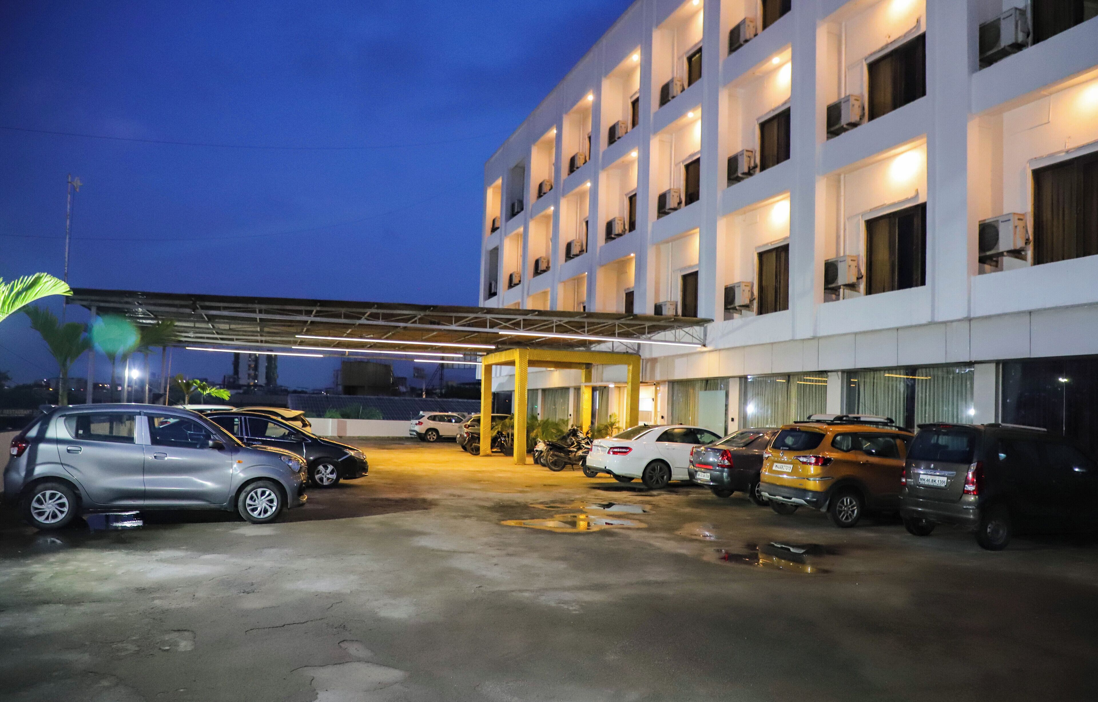 A multi-story hotel with a covered parking area.