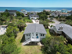 A residential area with houses, a central house with a porch, and a view of the ocean. - Beach Haven South - Minutes from the Beach, Second Row North Litchfield (Pawleys Island)
