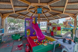A children's play area with a slide, ball pit, and various play structures. - Family Beachfront Apartment with Sea View in Agia Galini, Crete (Agia Galini)
