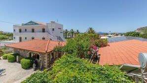 A hotel with a reception area, a rooftop with solar panels, and a view of the sea.