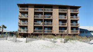 A multi-story hotel with balconies, located near a beach. - 10% off 3-7 nights through Dec. 1BR 1BA OF condo. Outdoor pool. Cozy getaway. (North Myrtle Beach)