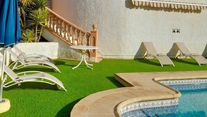 A multi-story building with balconies, a swimming pool, and a small lawn area. - Villa Margarita - Altea’s Pure Delight (Altea)