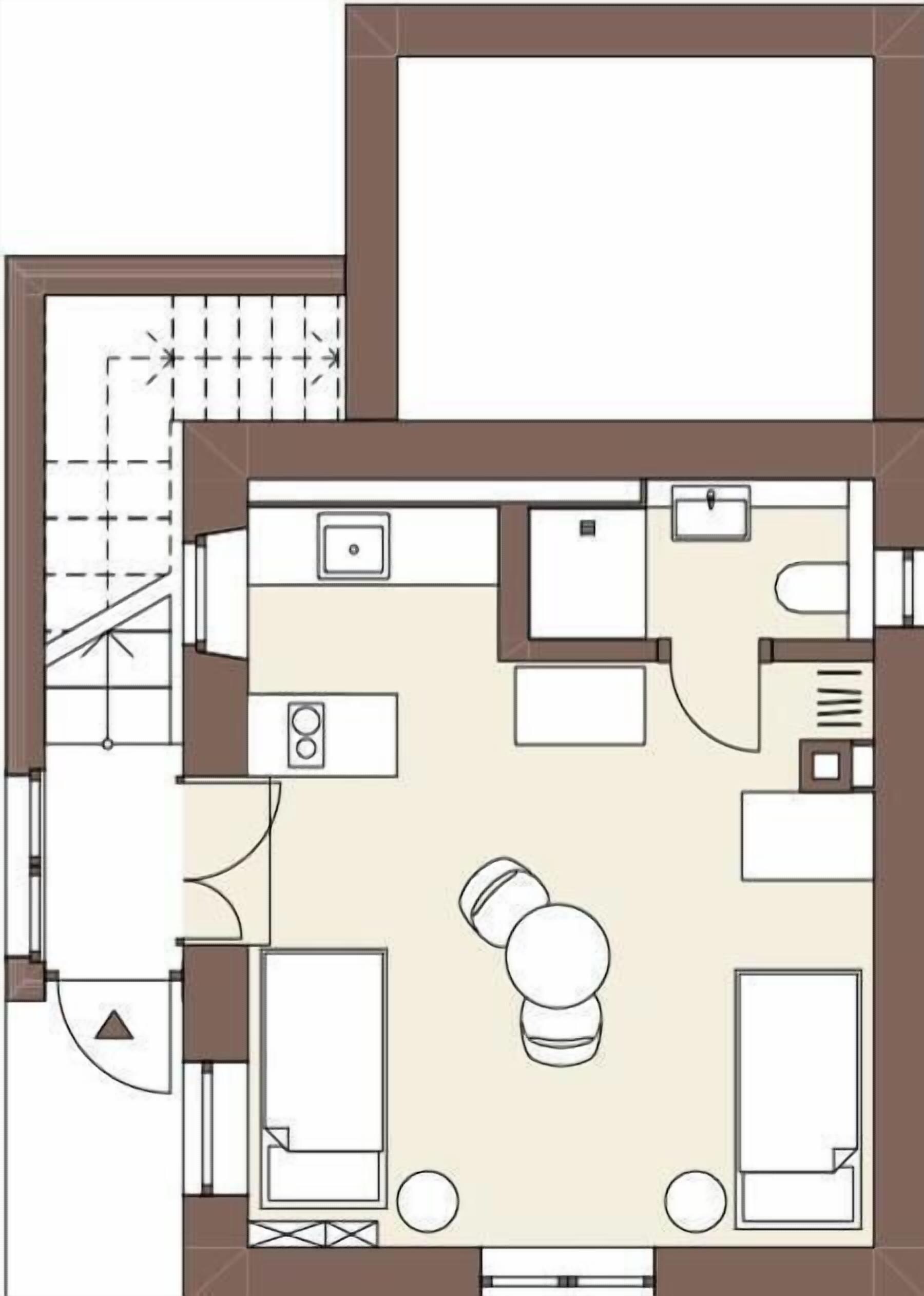 Un plan d’étage comprenant une cuisine, deux chambres, une salle de bain et un espace de vie.