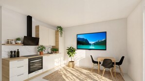 A modern kitchen with a built-in oven, a dining area with a table and chairs, and a TV displaying a mountain lake. - Apartment 'Christian - Wohnung 2' with Wi-Fi (Eitting)