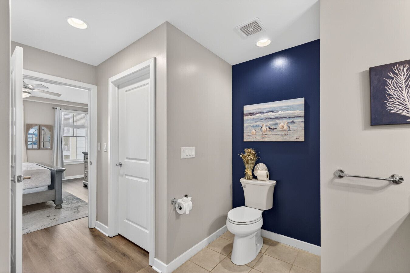 A bathroom with a toilet, a sink, and a shower area.
