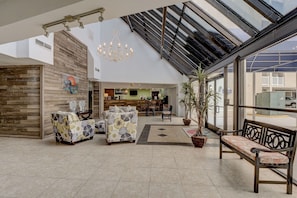 A spacious lobby with a high ceiling, a reception desk, and a seating area with patterned sofas. - 2 Bedroom, 2 Bathroom 5th Floor Oceanfront Condo (North Topsail Beach)