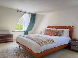 A bedroom with a wooden bed, a window with curtains, a nightstand, and a chest of drawers. - Charming Foresters Cottage in Blair Castle Estate (North Ayrshire Council)