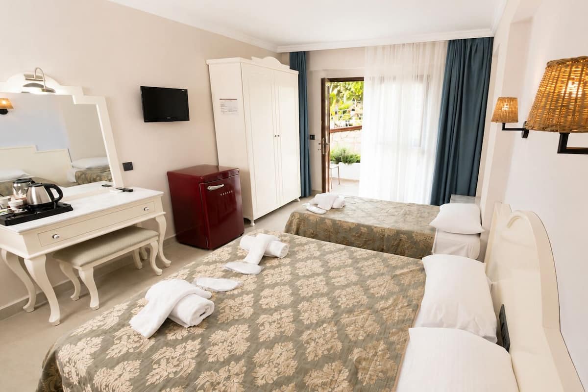 Chambre triple, vue sur le jardin | Coffre-fort, rideaux dâobscurcissement, accĂšs au Wi-Fi (inclus)