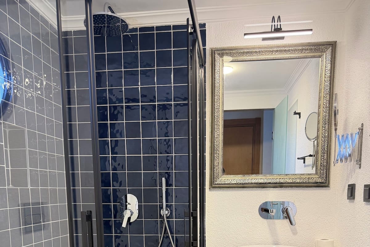 Shower, hair dryer, slippers, towels
