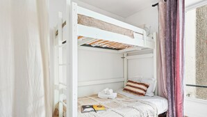 A bunk bed room with a window, curtains, and a view of the outside. - Studio Near Eiffel & Musée d'Orsay (Paris)