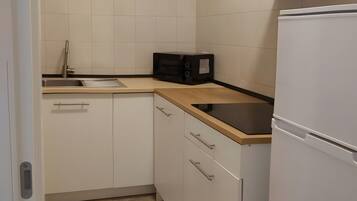 Fridge, stovetop, highchair, cookware/dishes/utensils