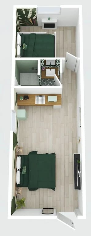 Una habitación pequeña con cama, un escritorio y zona de estar.